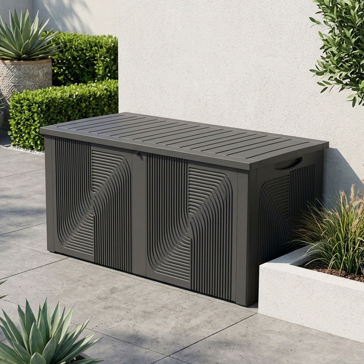 Modern black outdoor storage box with sculptural fluted wave texture and slatted lid on a contemporary garden patio.