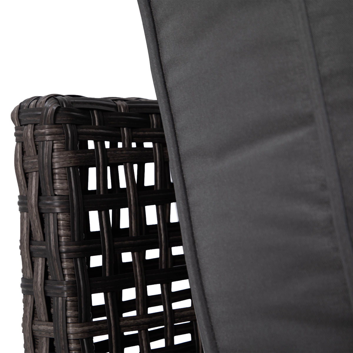 Close-up of piped grey back cushion beside woven rattan sofa frame