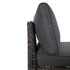 Thick grey patio sofa seat cushion above open-weave wicker base