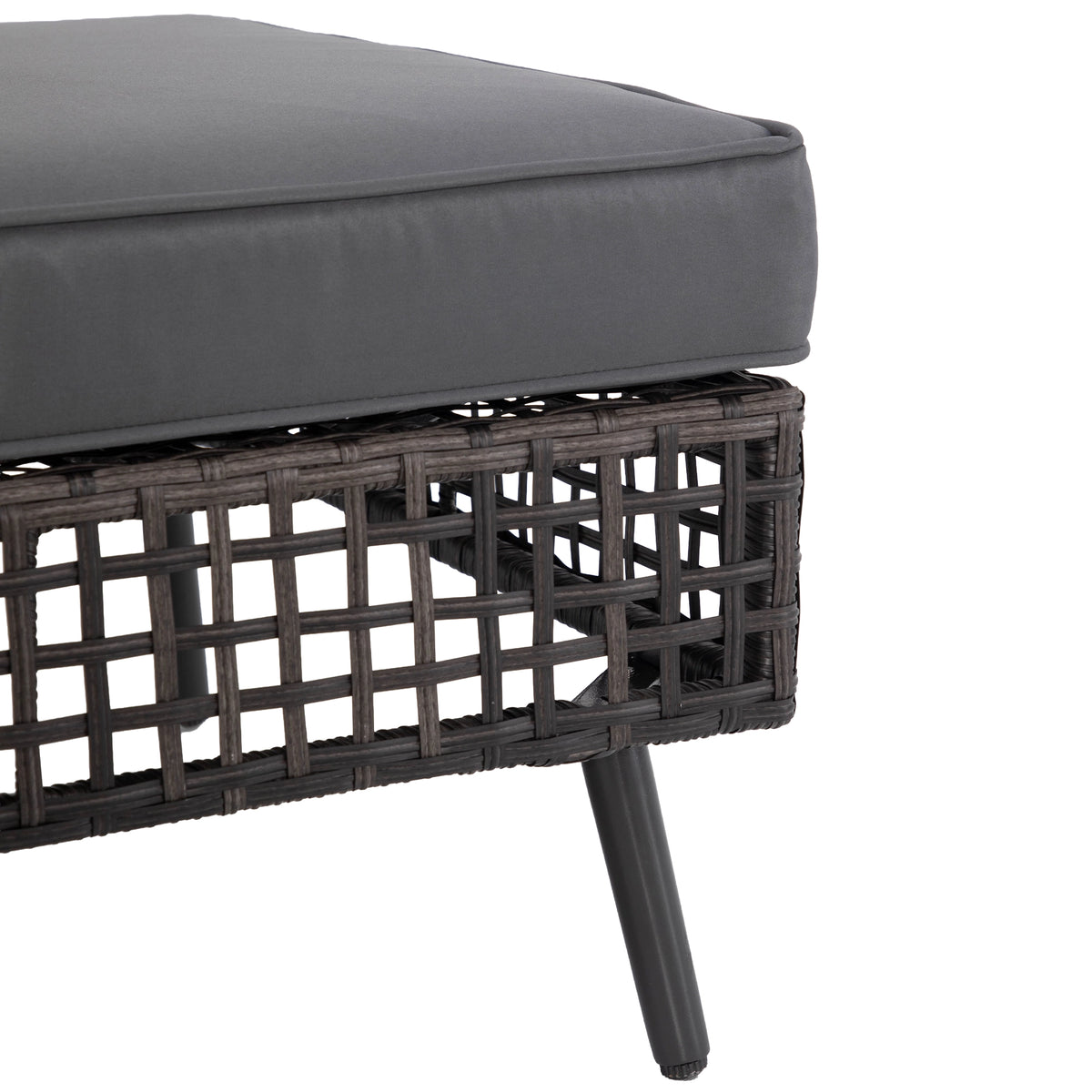 Adjustable foot detail on black tapered metal leg of wicker patio sofa
