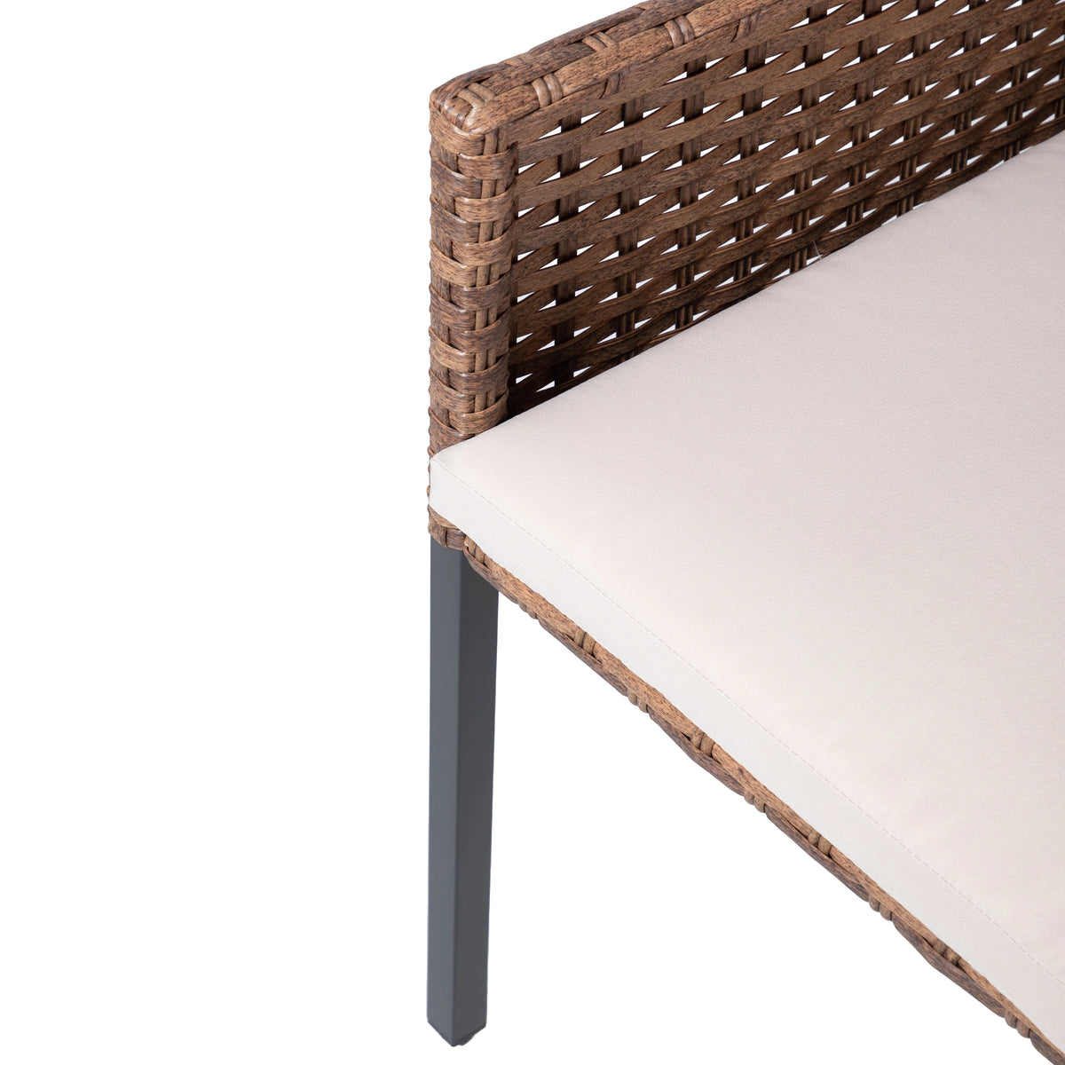 Close-up of woven rattan chair back and beige seat cushion