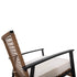 Side detail of wicker rocking chair backrest and metal armrest