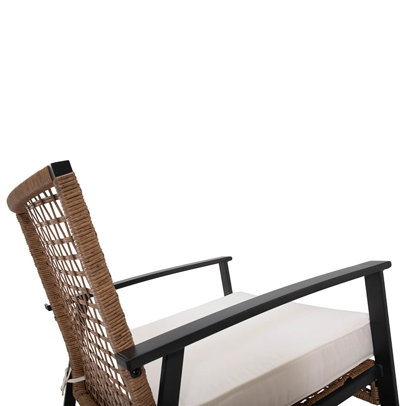 Side detail of wicker rocking chair backrest and metal armrest
