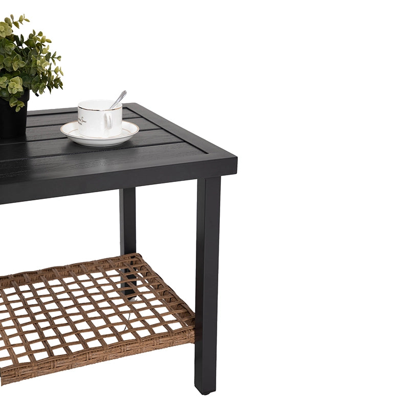 Outdoor wicker side table with lower shelf and decorative tabletop arrangement