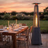 Tall propane outdoor heater beside a dining table at sunset