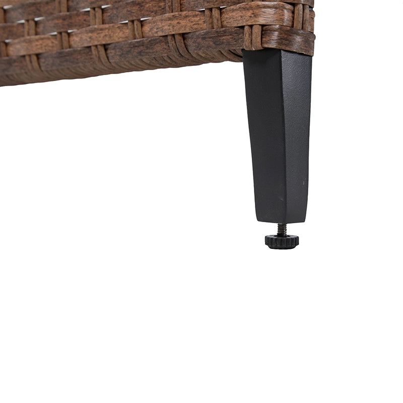 Close-up of black furniture leg beneath woven wicker patio table