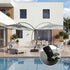 Cantilever patio umbrella beside a modern poolside lounge space