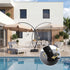 12 ft curved cantilever umbrella beside a modern poolside seating area