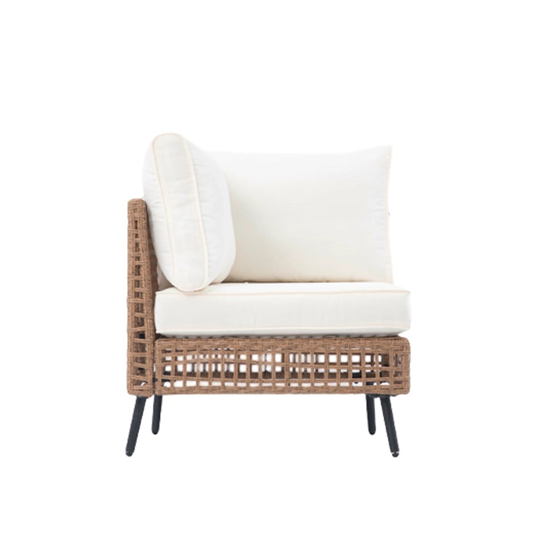 Front angled view of beige cushioned outdoor wicker armless sofa