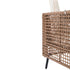 Close-up of brown wicker sofa back panel and black metal leg