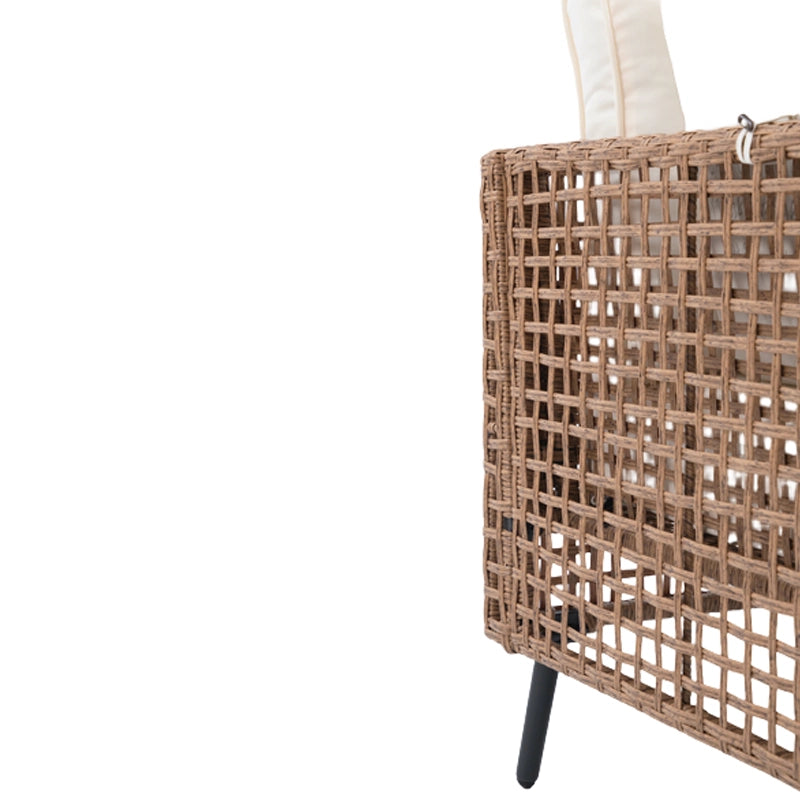 Close-up of brown wicker sofa back panel and black metal leg