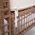 Beige sofa back cushion attachment strap on woven rattan frame