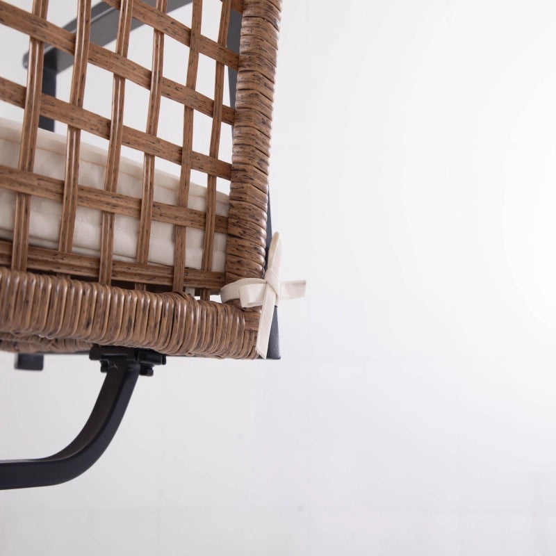 Close-up of woven wicker swivel dining chair backrest and curved metal support