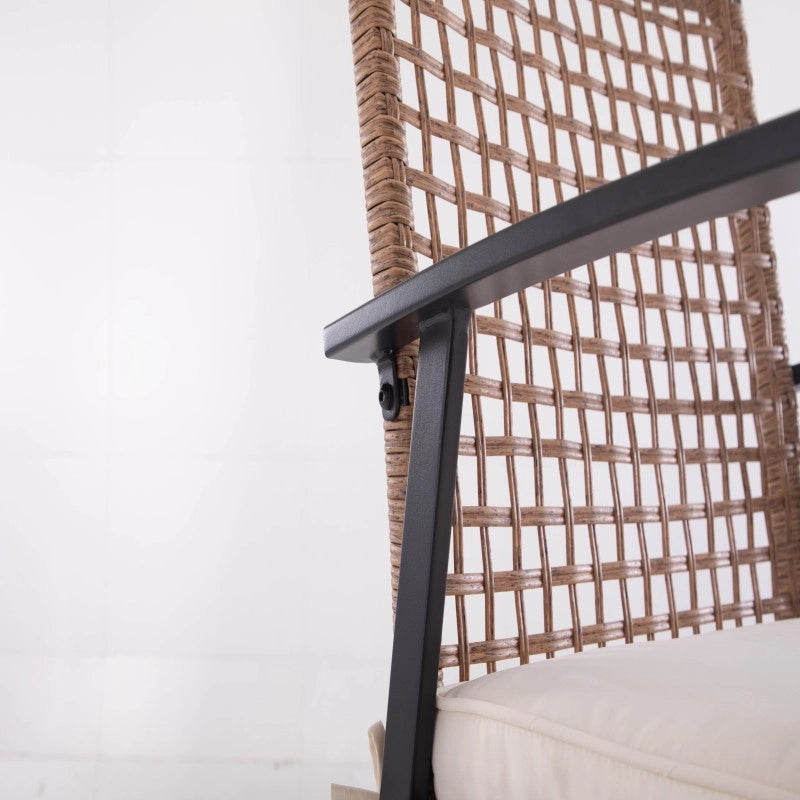 Side detail of wicker patio chair back and black metal armrest