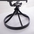Circular metal swivel base beneath outdoor wicker dining chair