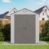 Expandable storage shed with closed double doors beside a house