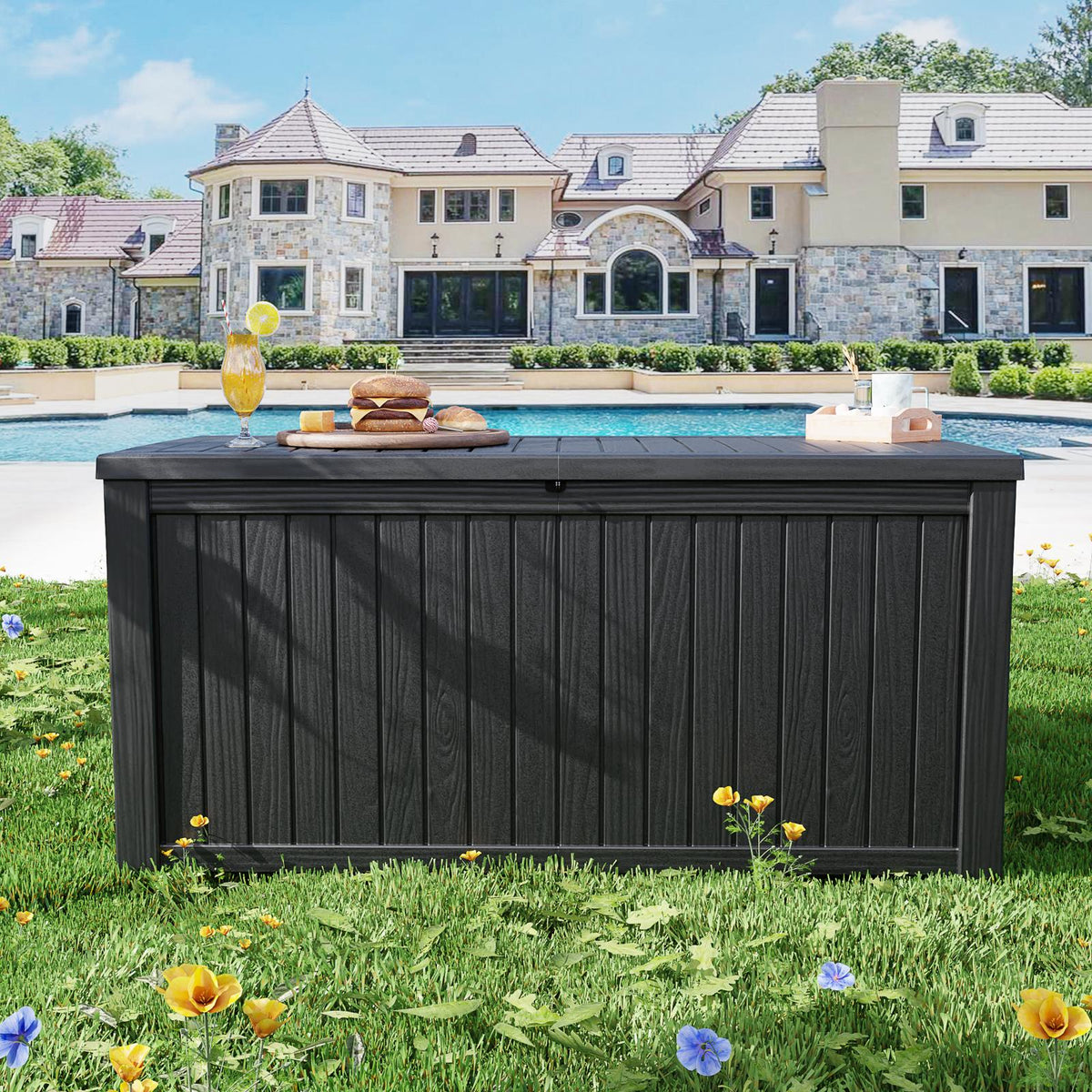 Black outdoor deck box in a backyard poolside setting