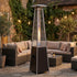 Outdoor glass tube patio heater beside lounge furniture