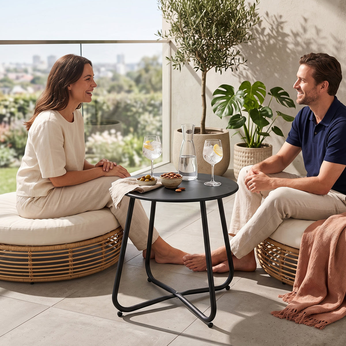 Yardgrace black metal round side table used beside a sofa for indoor and outdoor living spaces