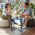 Peacock blue outdoor metal round side table beside patio seating for outdoor drinks and relaxation