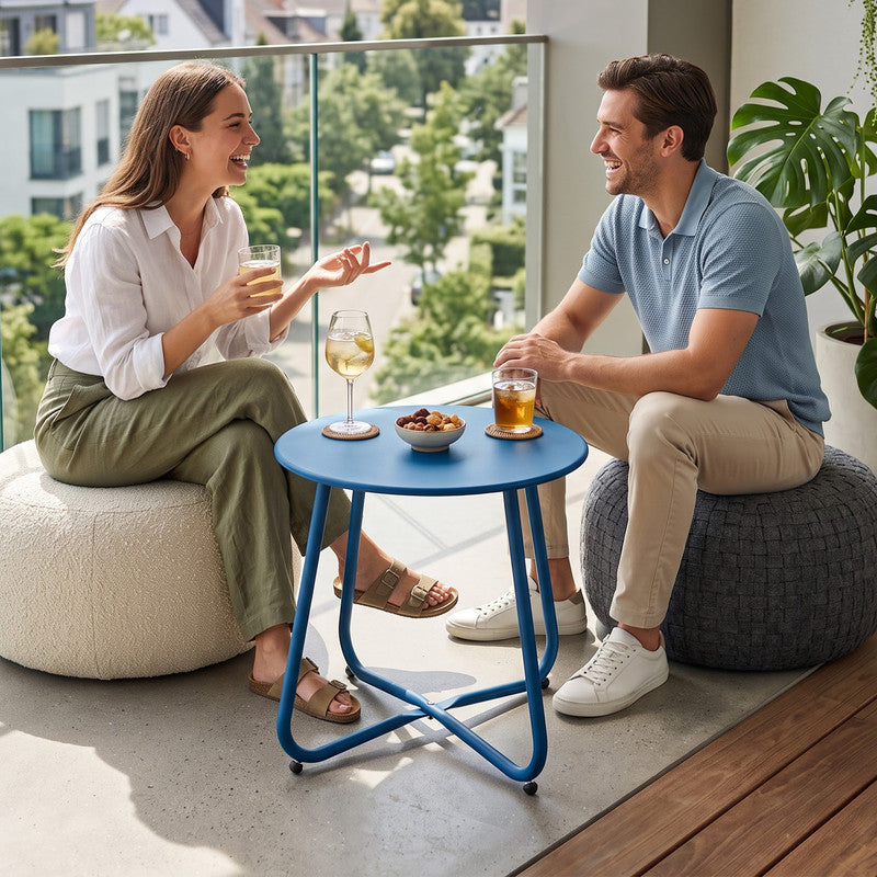 Peacock blue outdoor metal round side table beside patio seating for outdoor drinks and relaxation